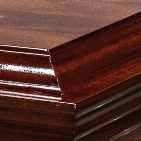 Corner of The Stanton casket showing the double raised lid and solid mahogany double mouldings in high gloss